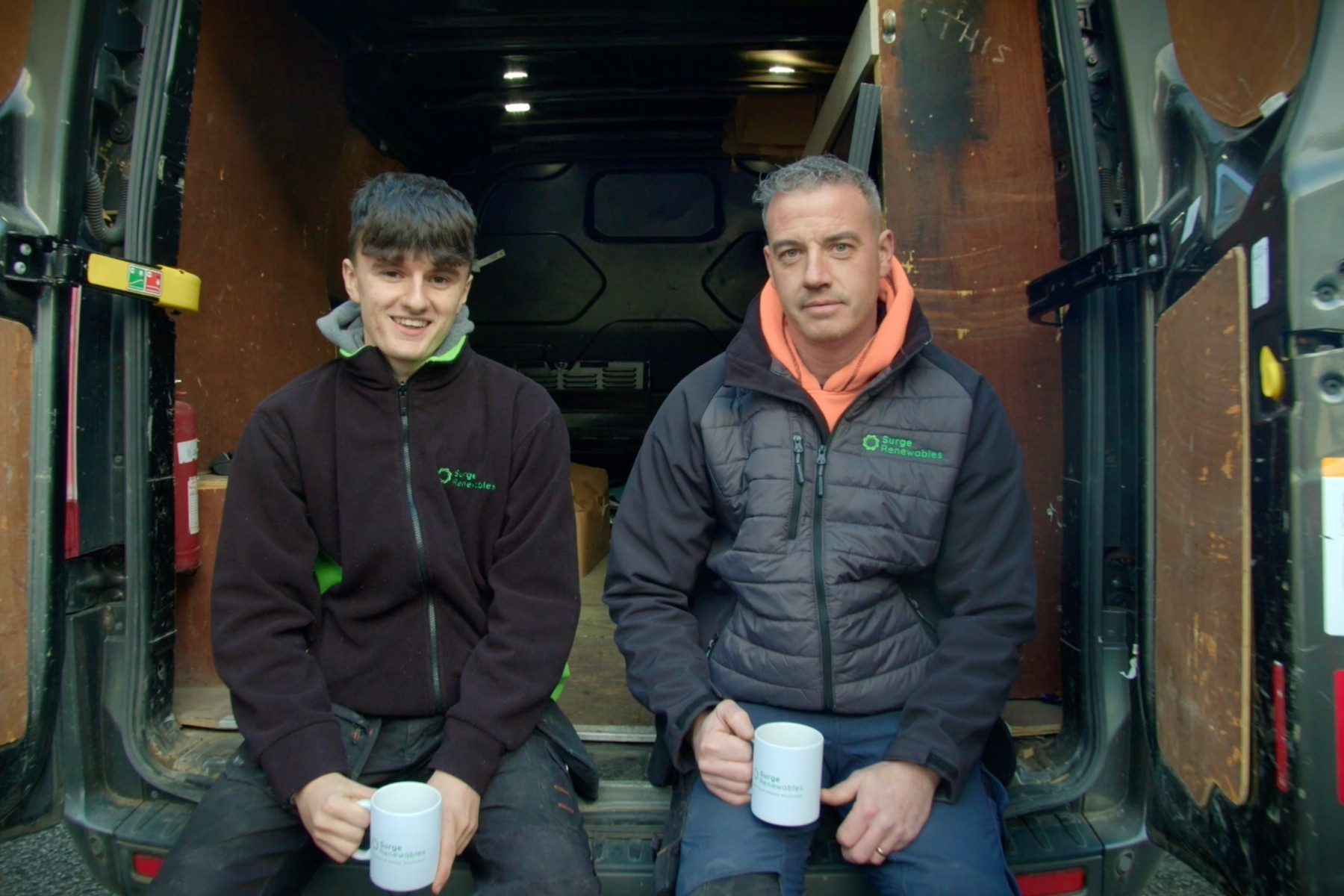 Installers sat in back of van with mugs