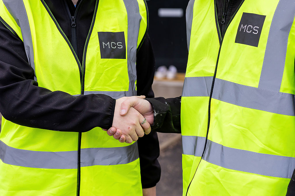 Installers shaking hands, close up.