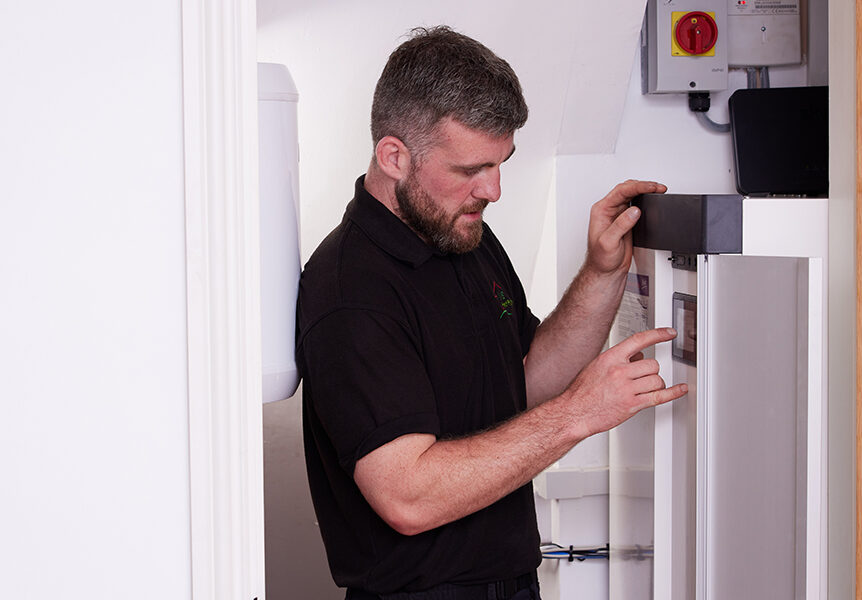 Installer working on unit indoors