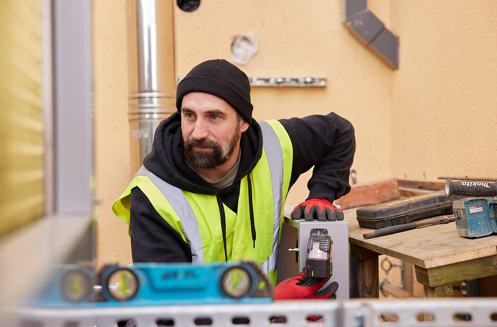 Installer crouched down with tools.