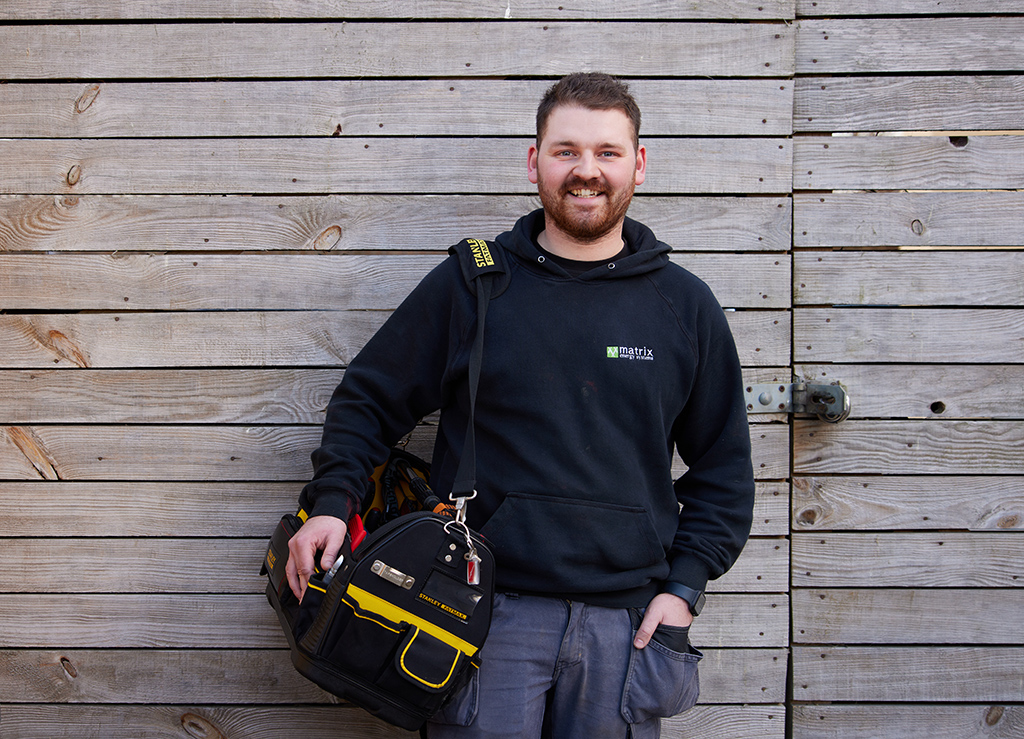 Installer in front of panel wall.