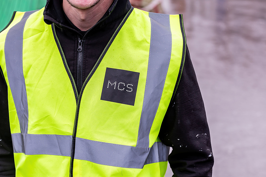 HI visibility jacket with MCS logo on it.