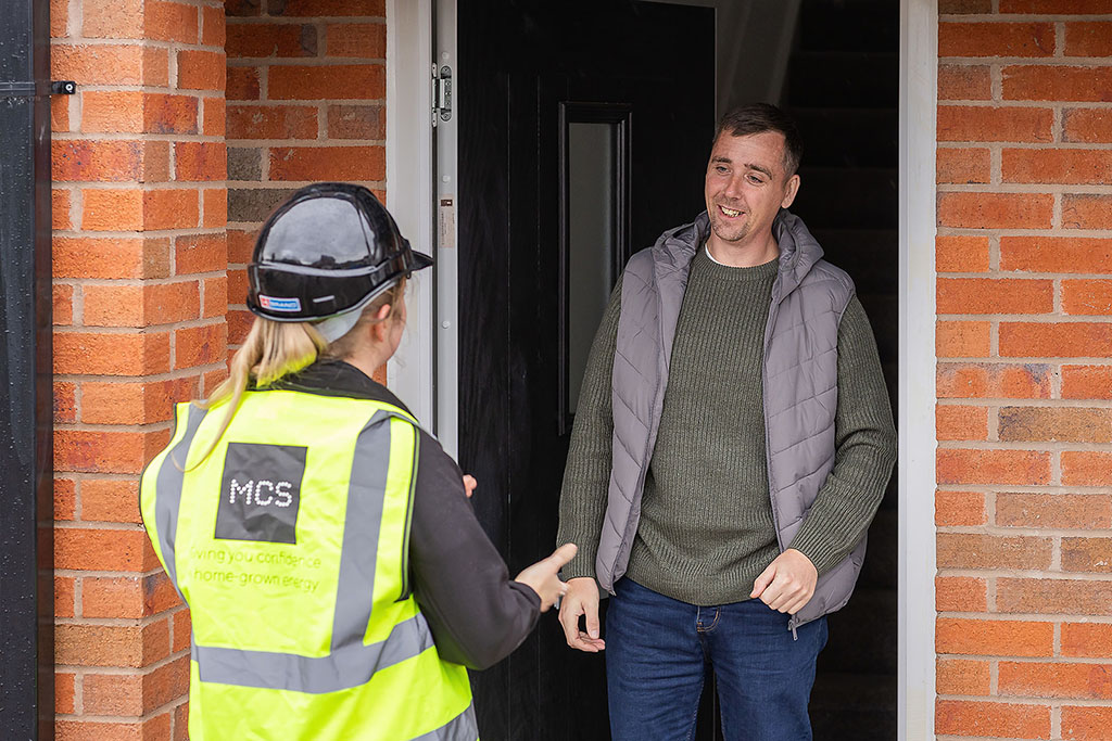 Homeowner and installer talking at doorway.