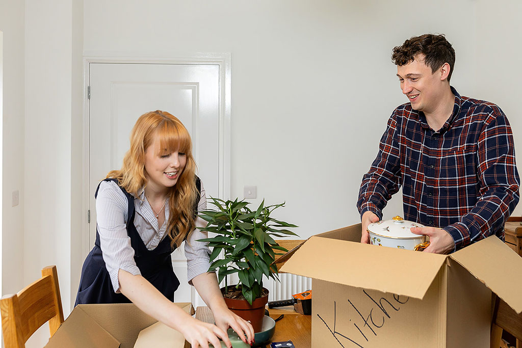 Homeowners unpacking boxes.