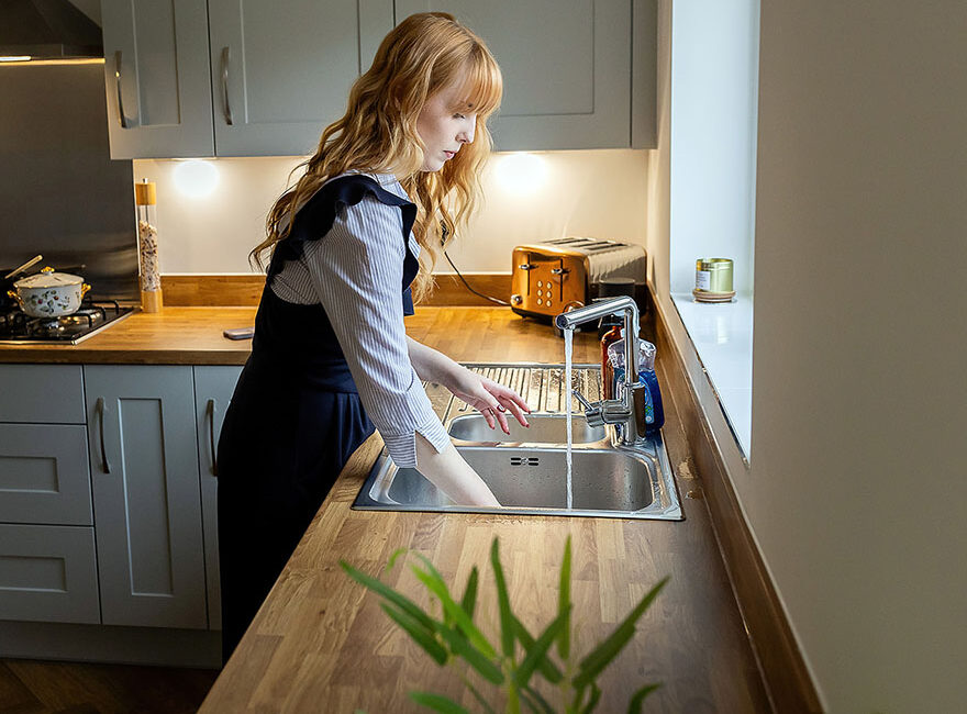 Woman doing washing up.