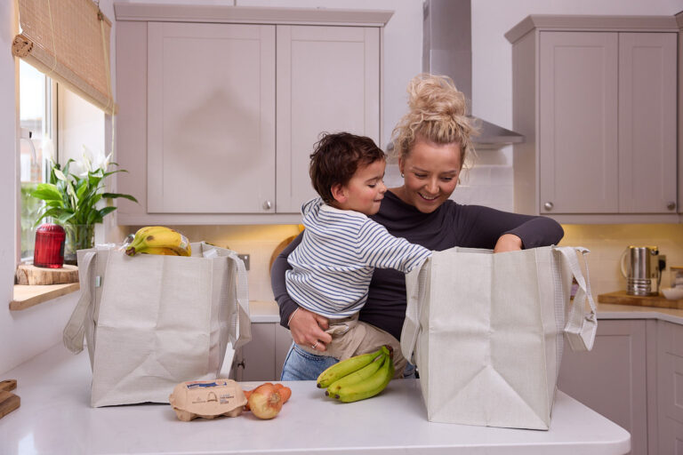 Mum and son looking through shopping.
