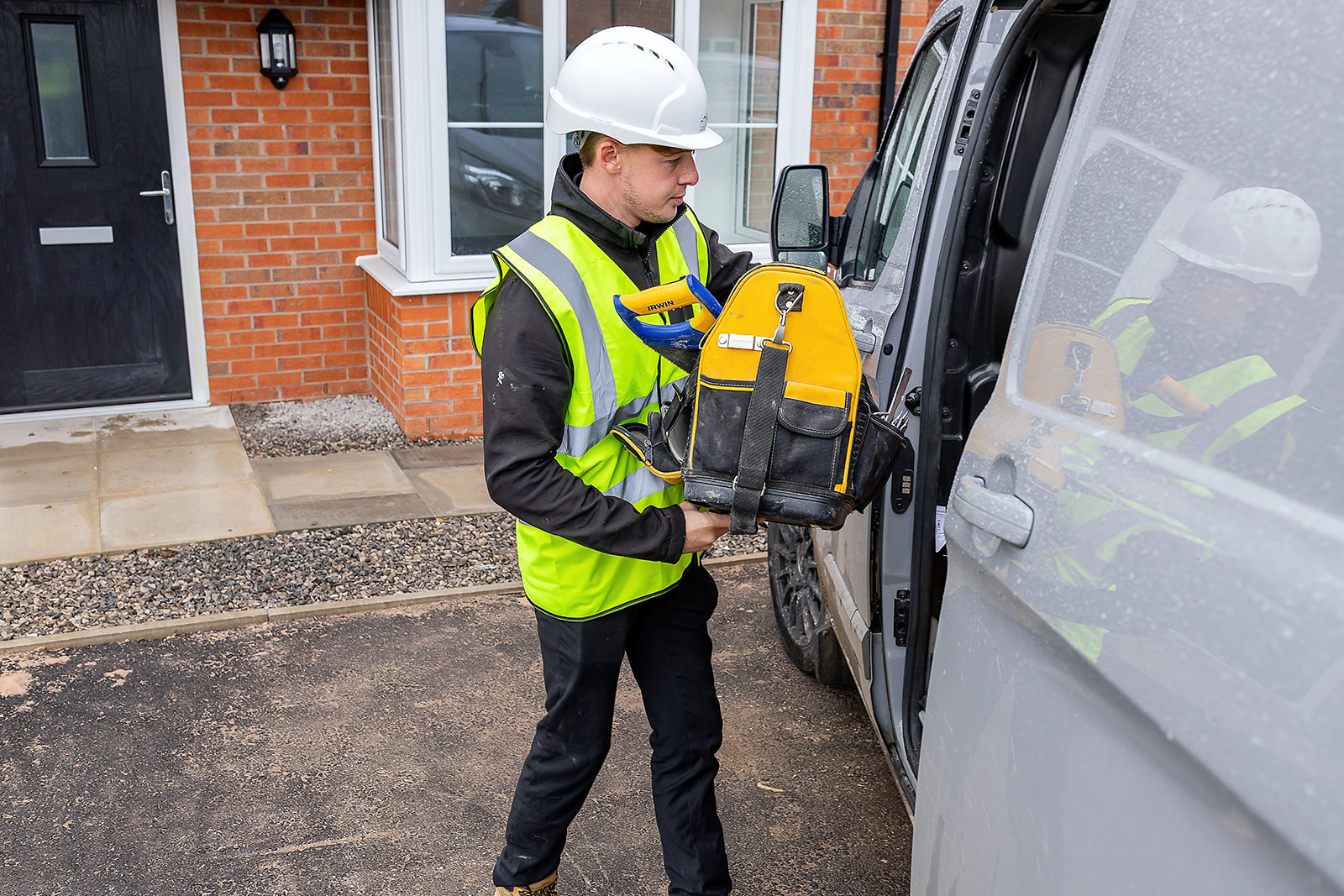 installer putting tools in van