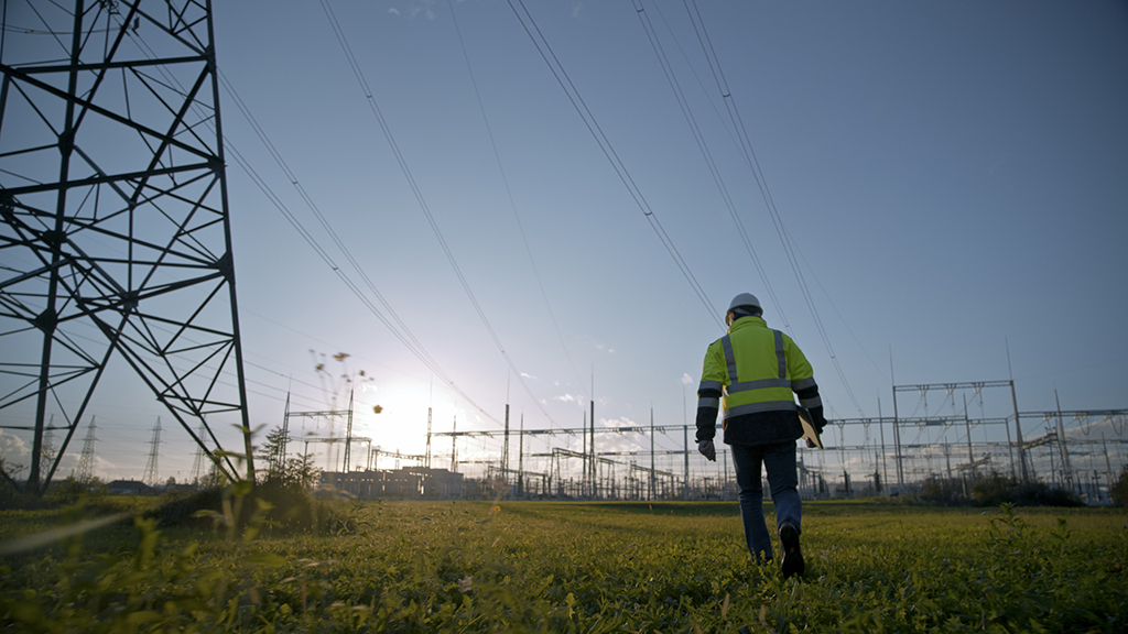 Engineer walking near pylons.