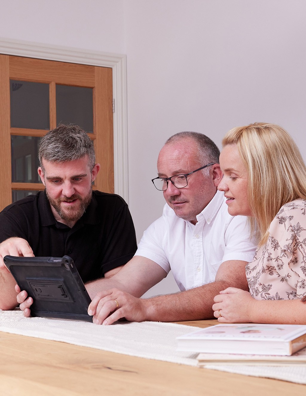 Homeowners with installer with tablet.