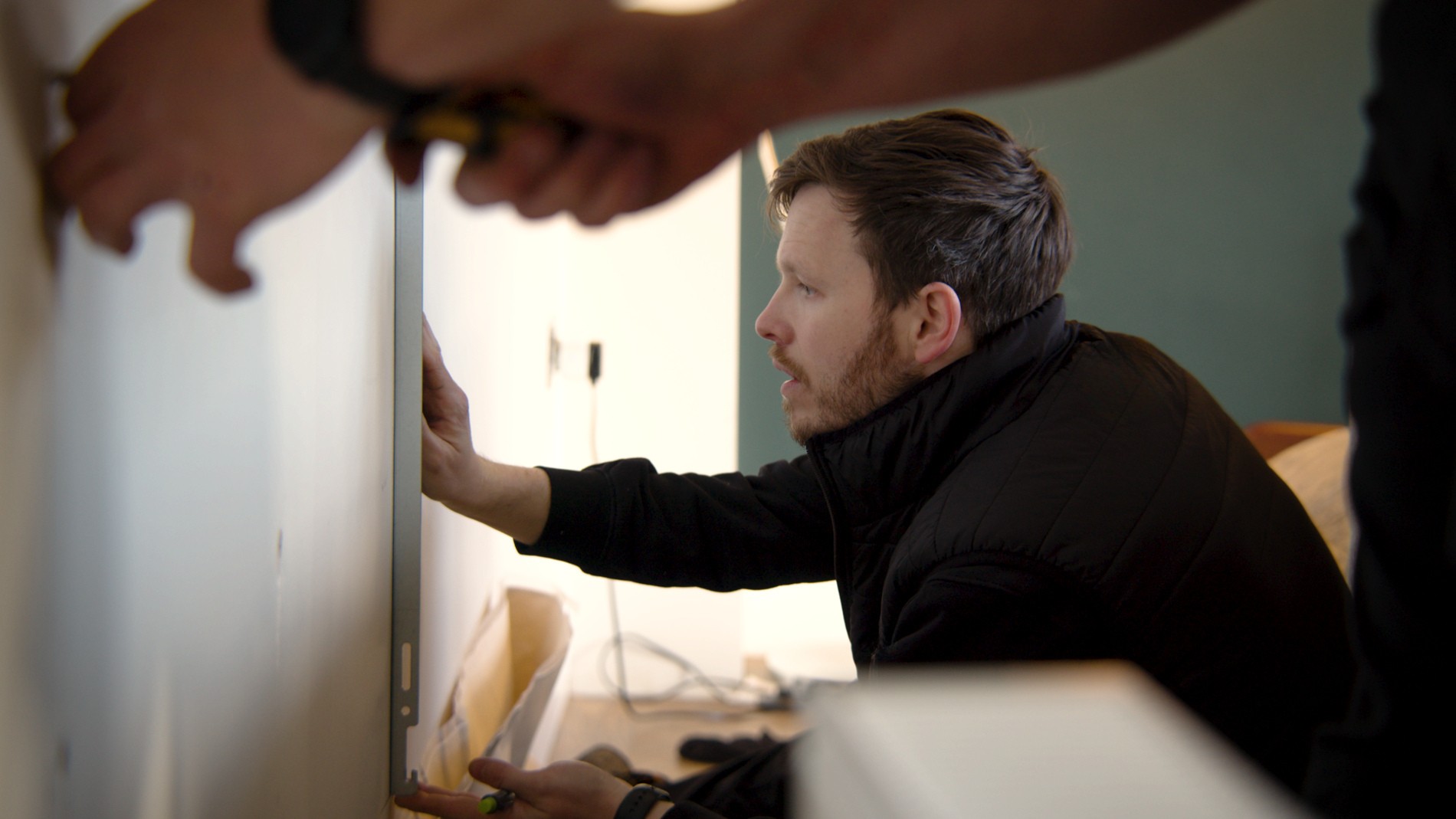 Installers taking measurements.