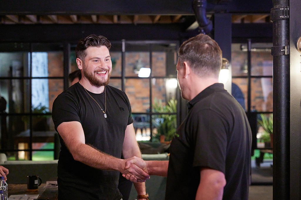 Installers laughing and shaking hands.