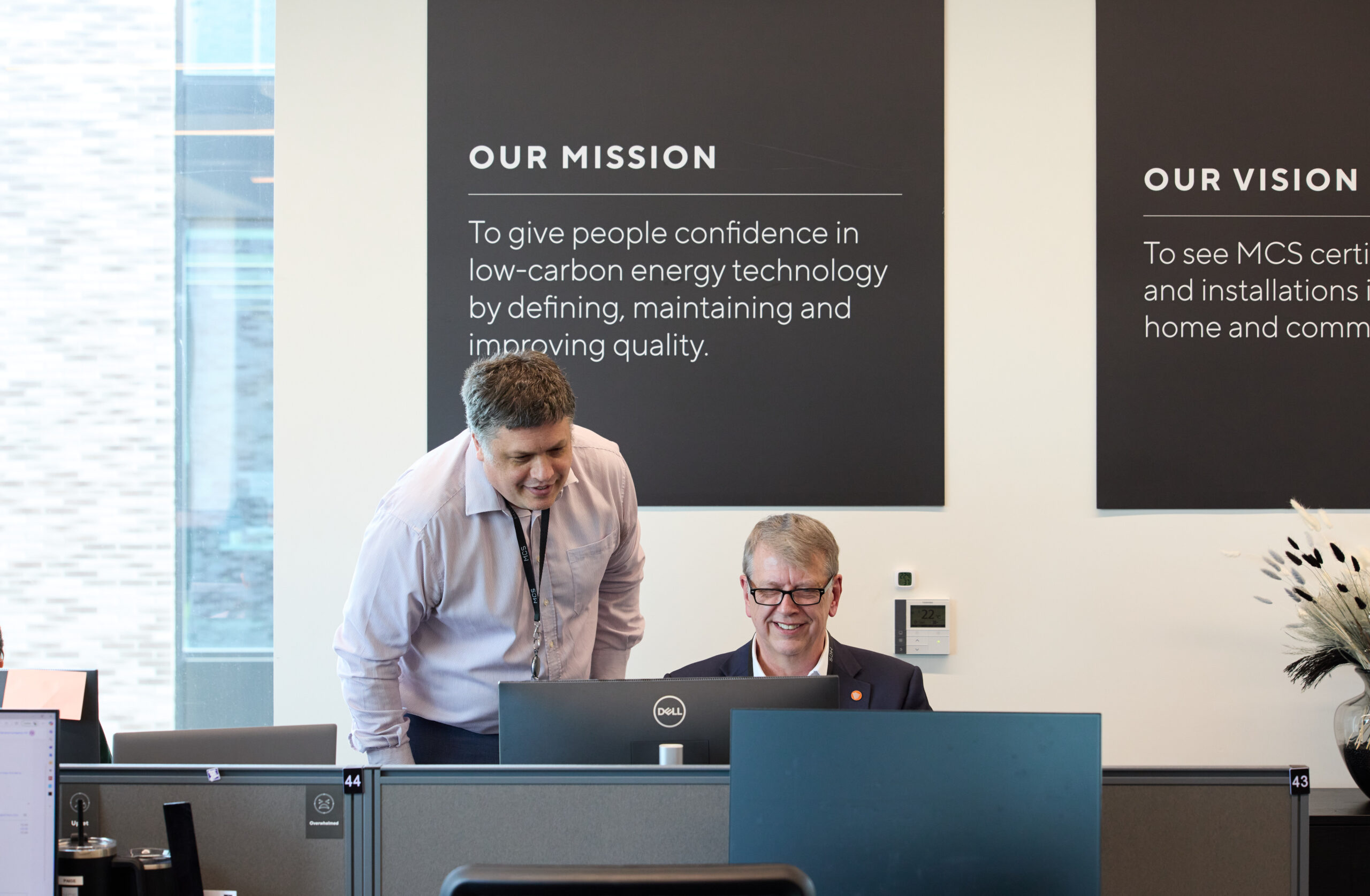 Two men looking at screen.