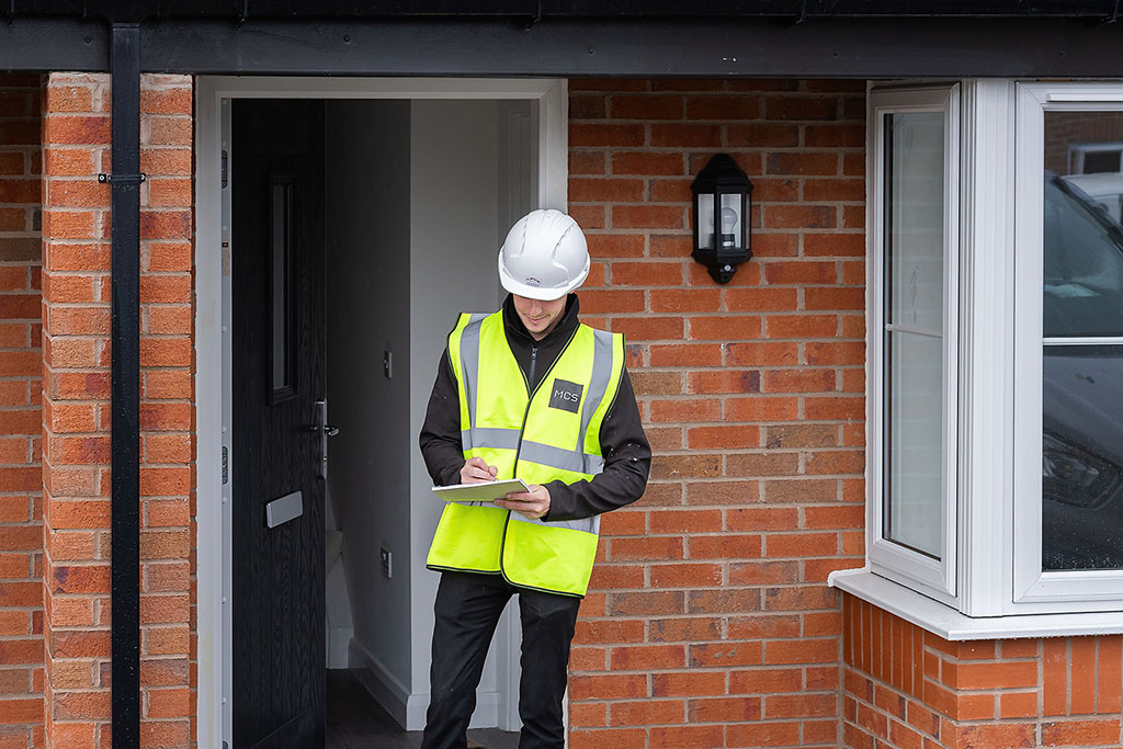Installer stood outside doorway.