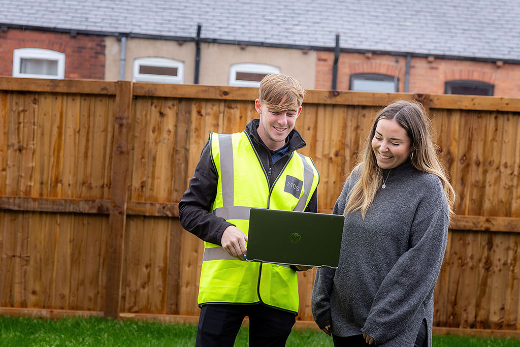 Installer and homeowner stood in garden.